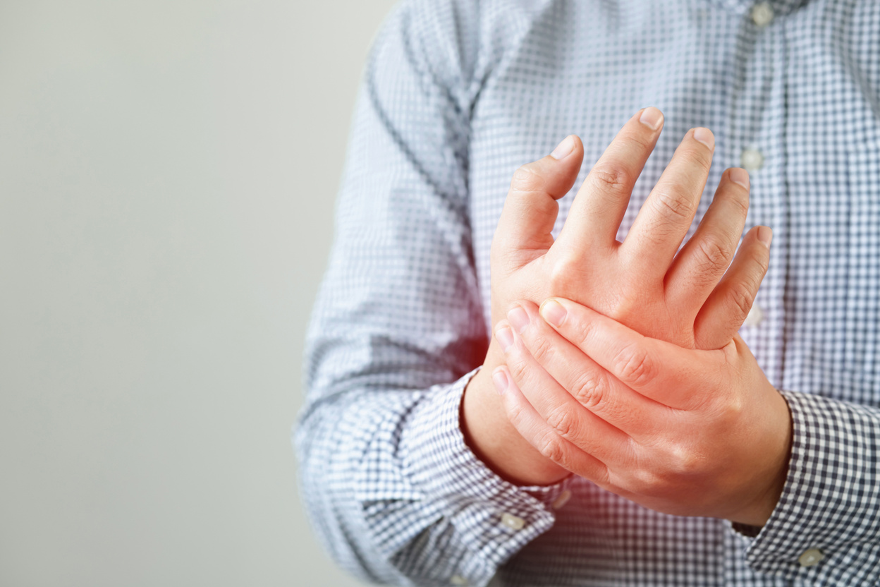 Man suffering from hand pain, bone pain